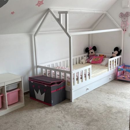 Łóżko domek z szufladą pojedynczą z barierkami dla dwulatka.