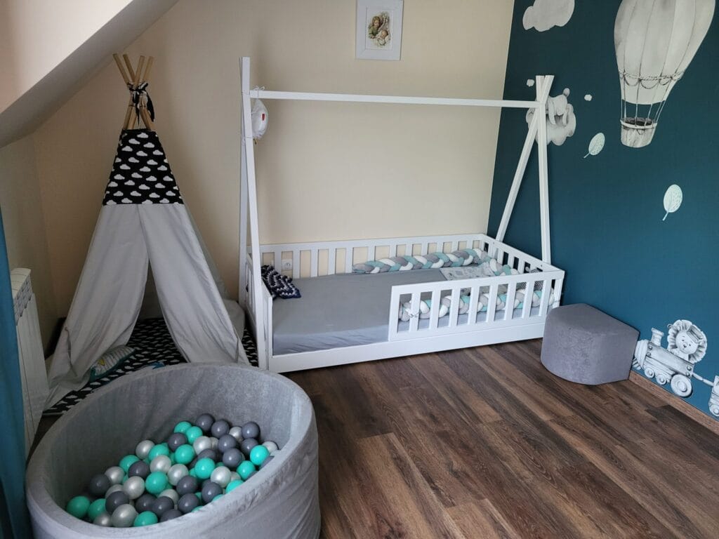 Łóżka dla dzieci w kształcie domku w aranżacji w dziecięcym pokoju.